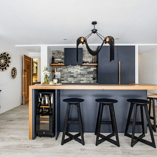 Photo of a small contemporary single-wall open plan kitchen in Sunshine Coast with an undermount sink, flat-panel cabinets, grey cabinets, ceramic splashback, ceramic floors, with island, grey floor, brown benchtop, wood benchtops, grey splashback and panelled appliances.