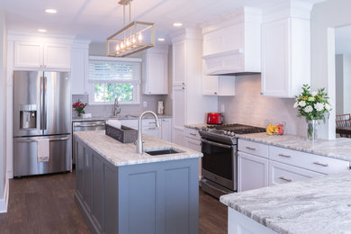 Transitional l-shaped dark wood floor and brown floor eat-in kitchen photo in Philadelphia with an undermount sink, shaker cabinets, white cabinets, granite countertops, gray backsplash, ceramic backsplash, stainless steel appliances, an island and gray countertops