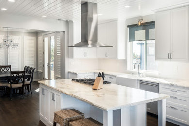 Inspiration for a mid-sized transitional u-shaped eat-in kitchen remodel in San Francisco with shaker cabinets, white cabinets and an island