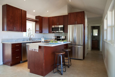 Example of a mid-sized transitional l-shaped porcelain tile open concept kitchen design in Hawaii with an undermount sink, shaker cabinets, dark wood cabinets, granite countertops, stainless steel appliances and an island