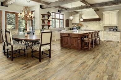 Eat-in kitchen - large rustic light wood floor eat-in kitchen idea in Chicago with granite countertops and an island