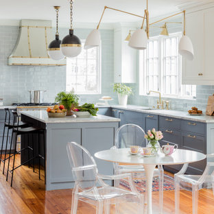 Transitional eat-in kitchen appliance - Inspiration for a transitional u-shaped medium tone wood floor, brown floor and exposed beam eat-in kitchen remodel in Boston with an undermount sink, shaker cabinets, gray cabinets, marble countertops, gray backsplash, subway tile backsplash, paneled appliances, an island and gray countertops