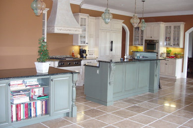 Eat-in kitchen - traditional eat-in kitchen idea in Other with raised-panel cabinets and white cabinets