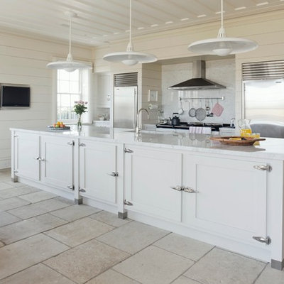Inspiration for a timeless eat-in kitchen remodel in Wiltshire with an undermount sink, white cabinets, white backsplash, stone slab backsplash and stainless steel appliances