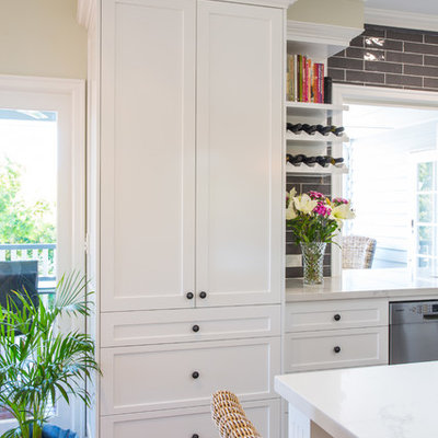 Large elegant l-shaped ceramic tile and gray floor open concept kitchen photo in Brisbane with an undermount sink, shaker cabinets, white cabinets, quartz countertops, gray backsplash, black appliances and an island