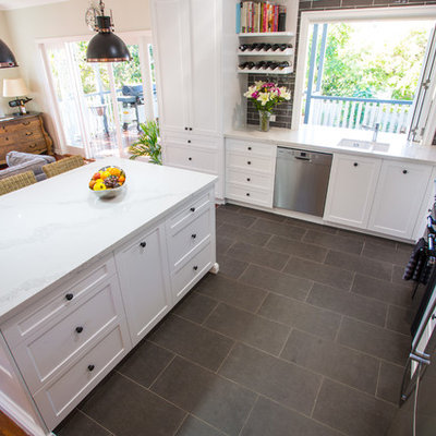Large elegant l-shaped ceramic tile and gray floor open concept kitchen photo in Brisbane with an undermount sink, shaker cabinets, white cabinets, quartz countertops, gray backsplash, subway tile backsplash, black appliances and an island