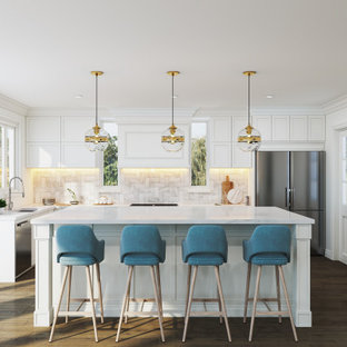 Inspiration for a transitional u-shaped kitchen in Melbourne with an undermount sink, recessed-panel cabinets, white cabinets, multi-coloured splashback, stainless steel appliances, medium hardwood floors, with island, brown floor and white benchtop.