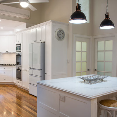 Open concept kitchen - large traditional u-shaped open concept kitchen idea in Brisbane with shaker cabinets, white cabinets, quartz countertops, white backsplash and an island