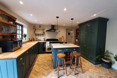 Inspiration for a country kitchen/diner in Other with blue cabinets, wood worktops, white splashback, ceramic splashback, medium hardwood flooring and an island.