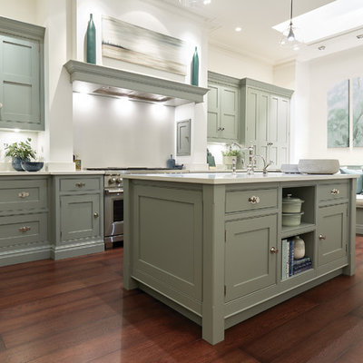 Kitchen - large transitional u-shaped dark wood floor and brown floor kitchen idea in London with shaker cabinets, green cabinets, quartzite countertops, white backsplash, stainless steel appliances, an island and white countertops