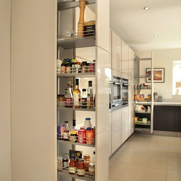 Handle-less high gloss cashmere & black kitchen with a variety of storage option