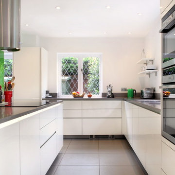 Handle-less high gloss white contemporary kitchen