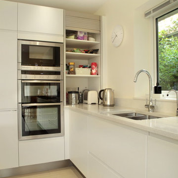 Handle-less white kitchen with hidden storage