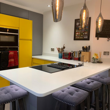 Handless family kitchen in custom yellow and mid grey