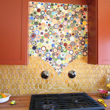 Handmade ceramic tile bubbles and fish, brick red cabinets