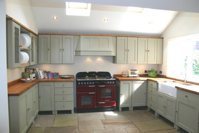 Photo of a medium sized farmhouse u-shaped kitchen/diner in Cheshire with a double-bowl sink, shaker cabinets, green cabinets, wood worktops and coloured appliances.