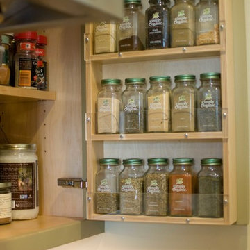 Handy spice rack inside the upper cabinet to the right of the range hood.