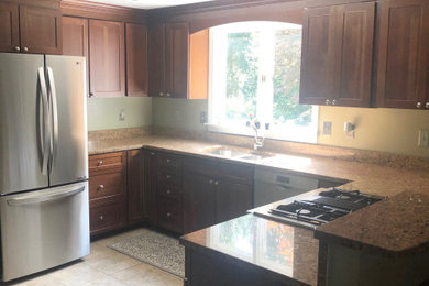 Inspiration for a large modern u-shaped eat-in kitchen remodel in Boston with granite countertops and multicolored countertops