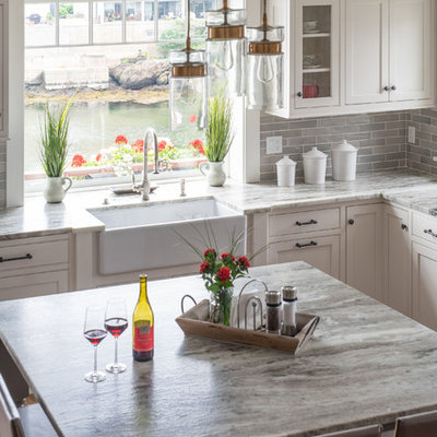 Inspiration for a large transitional l-shaped eat-in kitchen remodel in Boston with a farmhouse sink, beaded inset cabinets, white cabinets, marble countertops, gray backsplash, subway tile backsplash, stainless steel appliances, an island and gray countertops