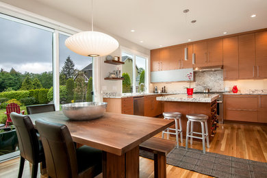 Mid-sized trendy u-shaped medium tone wood floor and brown floor eat-in kitchen photo in Boise with flat-panel cabinets, brown cabinets, granite countertops, white backsplash, stone slab backsplash, an undermount sink, paneled appliances, an island and gray countertops