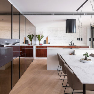 Inspiration for a small contemporary galley eat-in kitchen in Sydney with an undermount sink, flat-panel cabinets, marble benchtops, white splashback, marble splashback, light hardwood floors, with island, white benchtop, dark wood cabinets and brown floor.