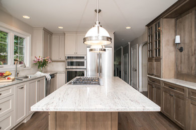 Open concept kitchen - large traditional l-shaped light wood floor and beige floor open concept kitchen idea in Detroit with an undermount sink, shaker cabinets, gray cabinets, granite countertops, white backsplash, subway tile backsplash, stainless steel appliances and an island