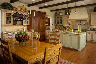 Mid-sized cottage galley medium tone wood floor and brown floor eat-in kitchen photo in New York with recessed-panel cabinets, white cabinets, granite countertops, green backsplash, porcelain backsplash, paneled appliances and an island
