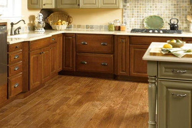 Eat-in kitchen - l-shaped light wood floor eat-in kitchen idea in Seattle with beaded inset cabinets and medium tone wood cabinets