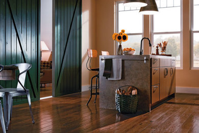 Example of a large urban galley medium tone wood floor eat-in kitchen design in Other with flat-panel cabinets, medium tone wood cabinets, solid surface countertops and an island