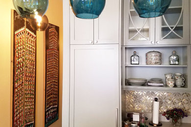 Inspiration for an eclectic galley ceramic tile and gray floor eat-in kitchen remodel in New York with an undermount sink, raised-panel cabinets, blue cabinets, quartz countertops, multicolored backsplash, glass tile backsplash, stainless steel appliances, no island and white countertops