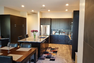 This is an example of a large contemporary u-shaped kitchen/diner in Phoenix with a submerged sink, flat-panel cabinets, dark wood cabinets, granite worktops, multi-coloured splashback, stone slab splashback, stainless steel appliances, limestone flooring, an island and beige floors.