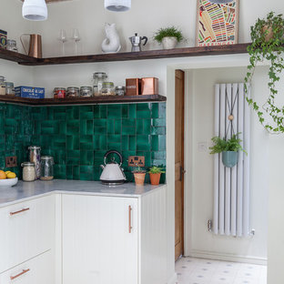 Small eclectic l-shaped separate kitchen in London with an integrated sink, shaker cabinets, white cabinets, marble benchtops, green splashback, ceramic splashback, panelled appliances, cement tiles, no island and white floor.