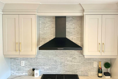 Inspiration for a small contemporary single-wall light wood floor and multicolored floor eat-in kitchen remodel in Toronto with an undermount sink, shaker cabinets, gray cabinets, quartz countertops, gray backsplash, porcelain backsplash, stainless steel appliances, an island and white countertops
