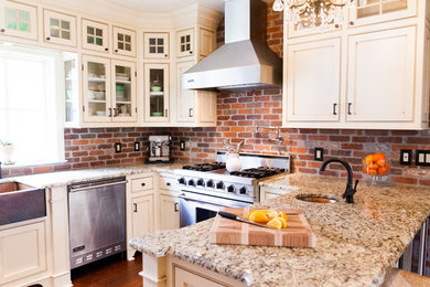 Eat-in kitchen - huge country u-shaped medium tone wood floor eat-in kitchen idea in New York with white cabinets, granite countertops, a farmhouse sink, red backsplash, stainless steel appliances, no island, beaded inset cabinets and brick backsplash
