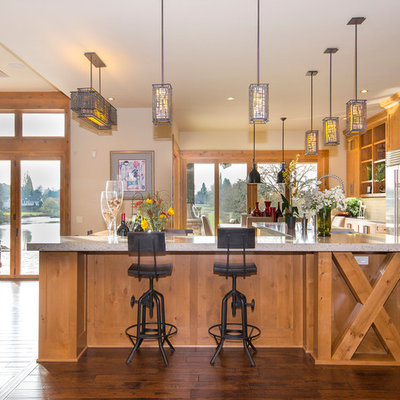 Inspiration for a rustic dark wood floor open concept kitchen remodel in Portland with gray countertops, shaker cabinets, medium tone wood cabinets, stainless steel appliances and an island