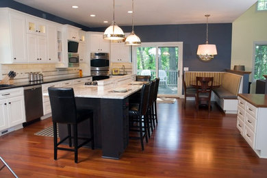Large elegant l-shaped dark wood floor open concept kitchen photo in Minneapolis with an undermount sink, recessed-panel cabinets, white cabinets, granite countertops, white backsplash, stone tile backsplash and stainless steel appliances