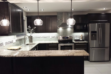 Inspiration for a mid-sized contemporary l-shaped ceramic tile eat-in kitchen remodel in Toronto with an undermount sink, flat-panel cabinets, gray cabinets, granite countertops, gray backsplash, glass tile backsplash, stainless steel appliances and a peninsula