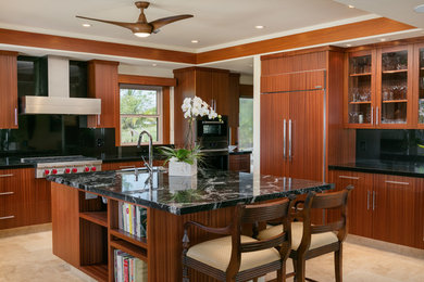 Island style u-shaped beige floor and ceramic tile eat-in kitchen photo in Hawaii with an undermount sink, flat-panel cabinets, medium tone wood cabinets, black backsplash, paneled appliances, an island and granite countertops