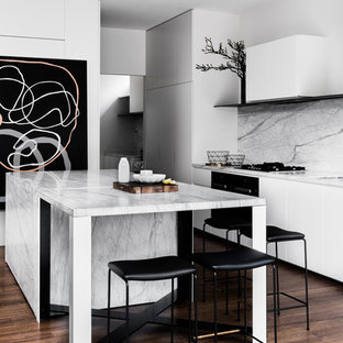 Inspiration for a contemporary kitchen in Melbourne with flat-panel cabinets, white cabinets, grey splashback, dark hardwood floors, with island, brown floor and grey benchtop.