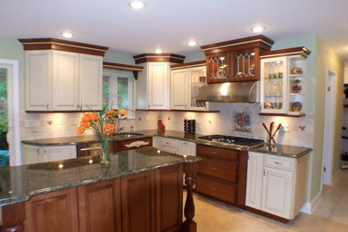 Elegant l-shaped ceramic tile eat-in kitchen photo in New York with an undermount sink, raised-panel cabinets, beige cabinets, granite countertops, beige backsplash, cement tile backsplash, stainless steel appliances and an island