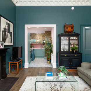 Inspiration for a small eclectic l-shaped open plan kitchen in Edinburgh with a single-bowl sink, shaker cabinets, blue cabinets, laminate benchtops, pink splashback, ceramic splashback, stainless steel appliances, vinyl floors, no island, multi-coloured floor and grey benchtop.