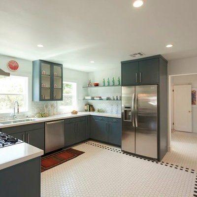 Eclectic u-shaped enclosed kitchen photo in Los Angeles with blue cabinets, white backsplash, subway tile backsplash and stainless steel appliances