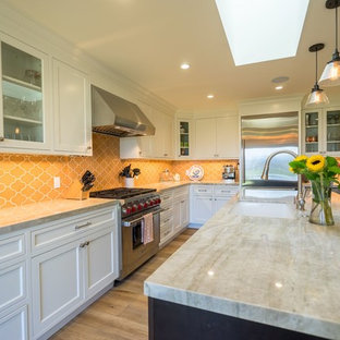 This is an example of a large contemporary l-shaped separate kitchen in Orange County with an undermount sink, shaker cabinets, white cabinets, granite benchtops, yellow splashback, mosaic tile splashback, stainless steel appliances, light hardwood floors and with island.