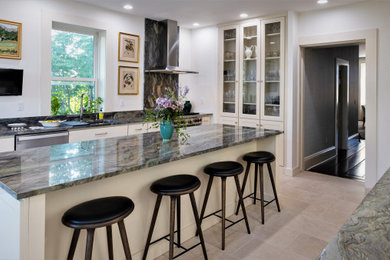 Inspiration for a large transitional galley limestone floor and beige floor kitchen remodel in Philadelphia with an undermount sink, white cabinets, granite countertops, an island, green countertops, recessed-panel cabinets and stainless steel appliances