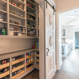 Photo of a large traditional l-shaped kitchen pantry in Houston with open cabinets, grey cabinets, dark hardwood floors and brown floor.
