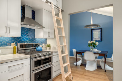 Mid-sized transitional galley medium tone wood floor eat-in kitchen photo in San Diego with an undermount sink, shaker cabinets, white cabinets, quartzite countertops, blue backsplash, porcelain backsplash, stainless steel appliances and no island