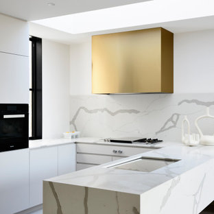 Design ideas for a contemporary u-shaped open plan kitchen in Melbourne with an undermount sink, marble benchtops, white splashback, marble splashback, black appliances, porcelain floors, no island, grey floor and white benchtop.