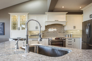 Inspiration for a mid-sized transitional l-shaped ceramic tile eat-in kitchen remodel in Toronto with a single-bowl sink, recessed-panel cabinets, white cabinets, quartzite countertops, gray backsplash, ceramic backsplash, stainless steel appliances and a peninsula