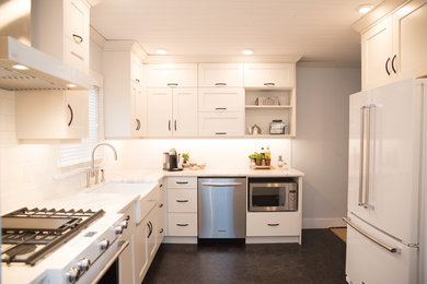 Enclosed kitchen - modern gray floor enclosed kitchen idea in Vancouver with a farmhouse sink, shaker cabinets, white cabinets, quartz countertops, white backsplash, stainless steel appliances and no island