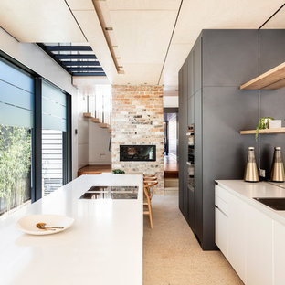 Design ideas for a contemporary galley eat-in kitchen in Sydney with a drop-in sink, flat-panel cabinets, grey cabinets, window splashback, concrete floors, with island, beige floor and white benchtop.